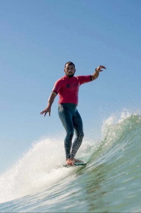 Daniel Procter from Wai-Tai nose riding his longboard